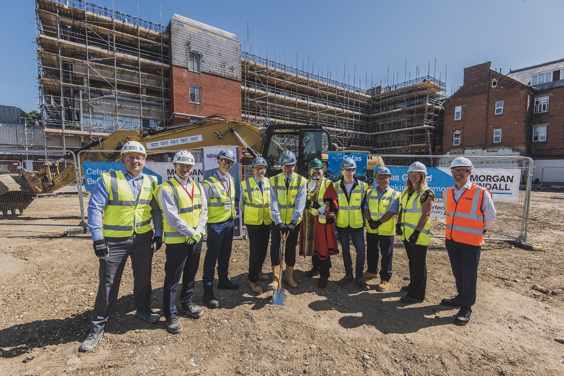 staff outside building construction
