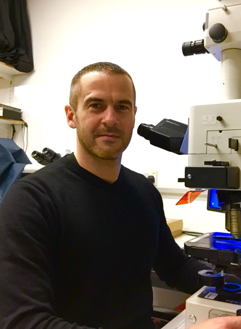 a man next to a microscope