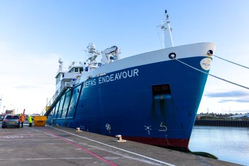 a ship in front of a harbour